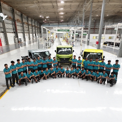 People gathered and sat in front of a Montra product range in the plant.