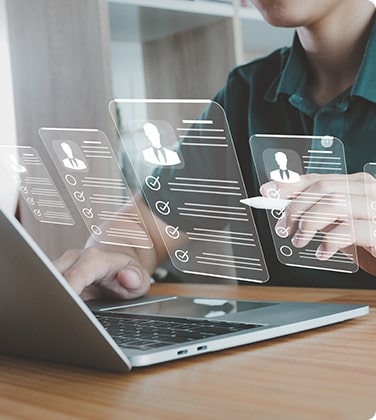 Man using a laptop with symbols representing profile checkouts of different individuals on the screen.