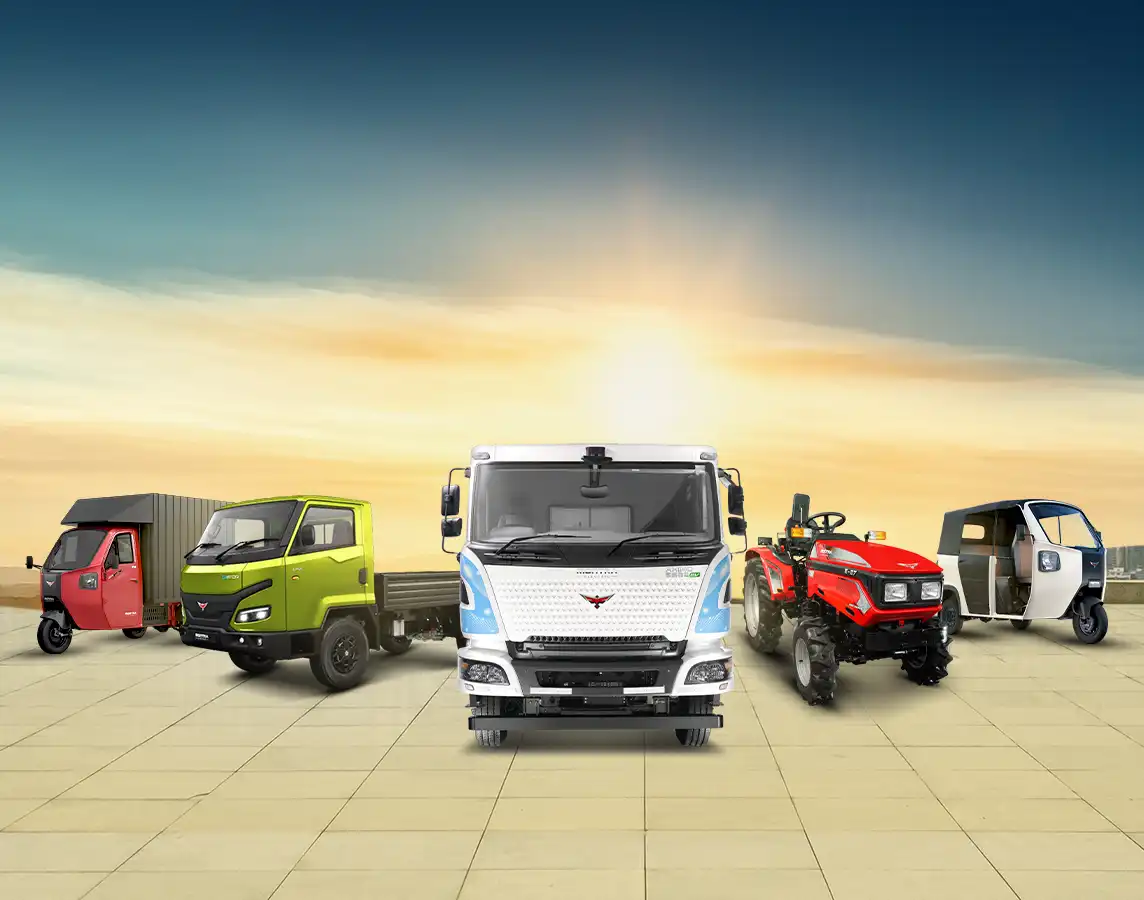 Product range of Montra Electric displayed in a lineup against a plain sky background, showcasing various electric vehicles.