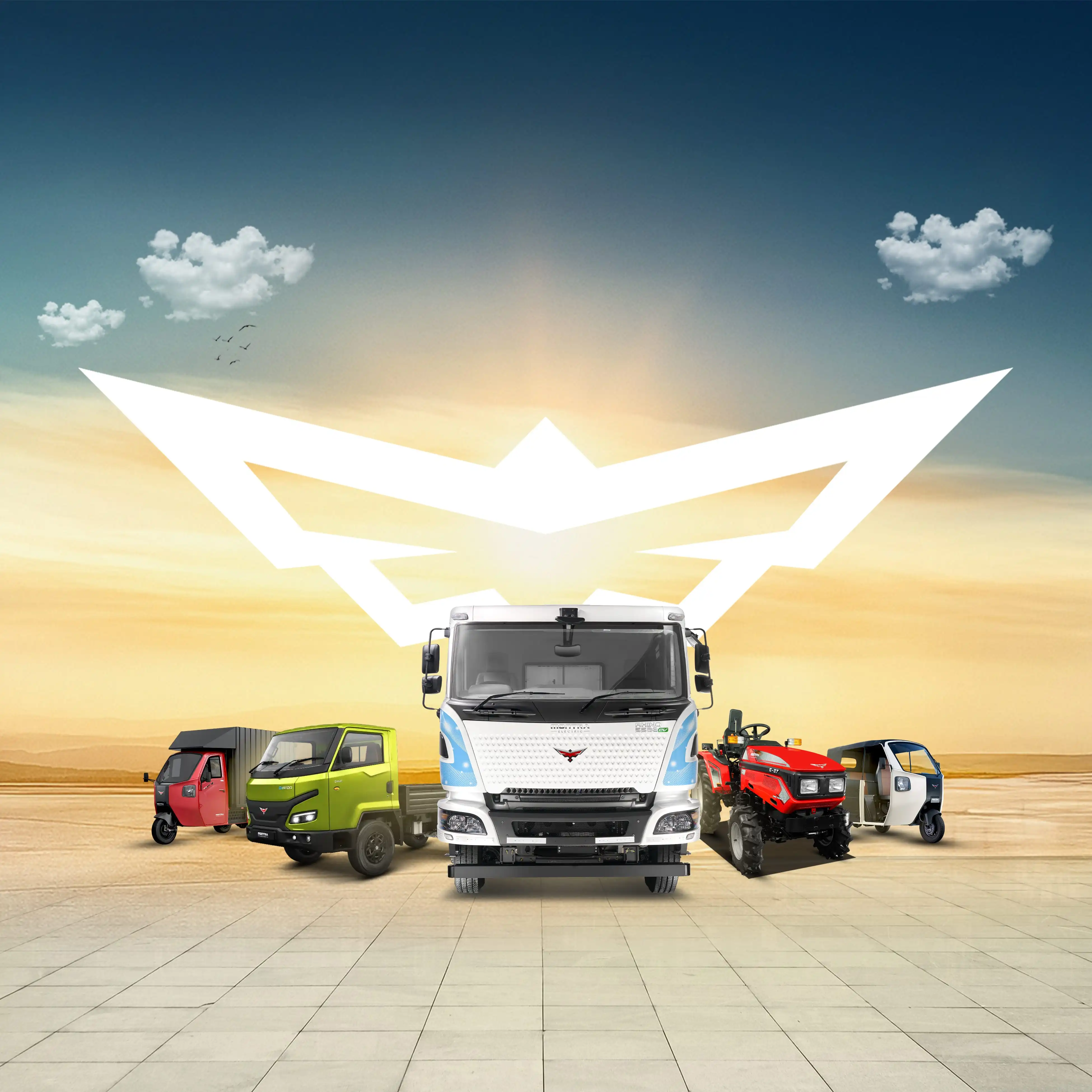 Modern glass-walled industrial building at sunset, with a reflective wet ground and a prominent red-and-blue logo on the exterior.